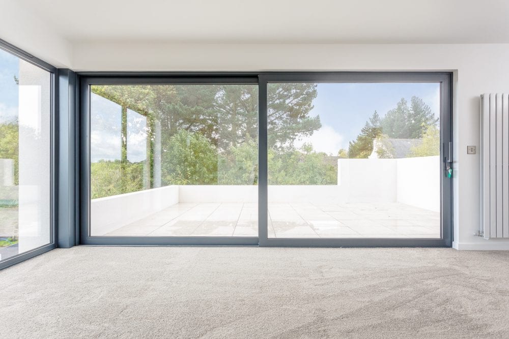 Wide aluminium sliding doors opening onto a terrace – for homes in Sutton