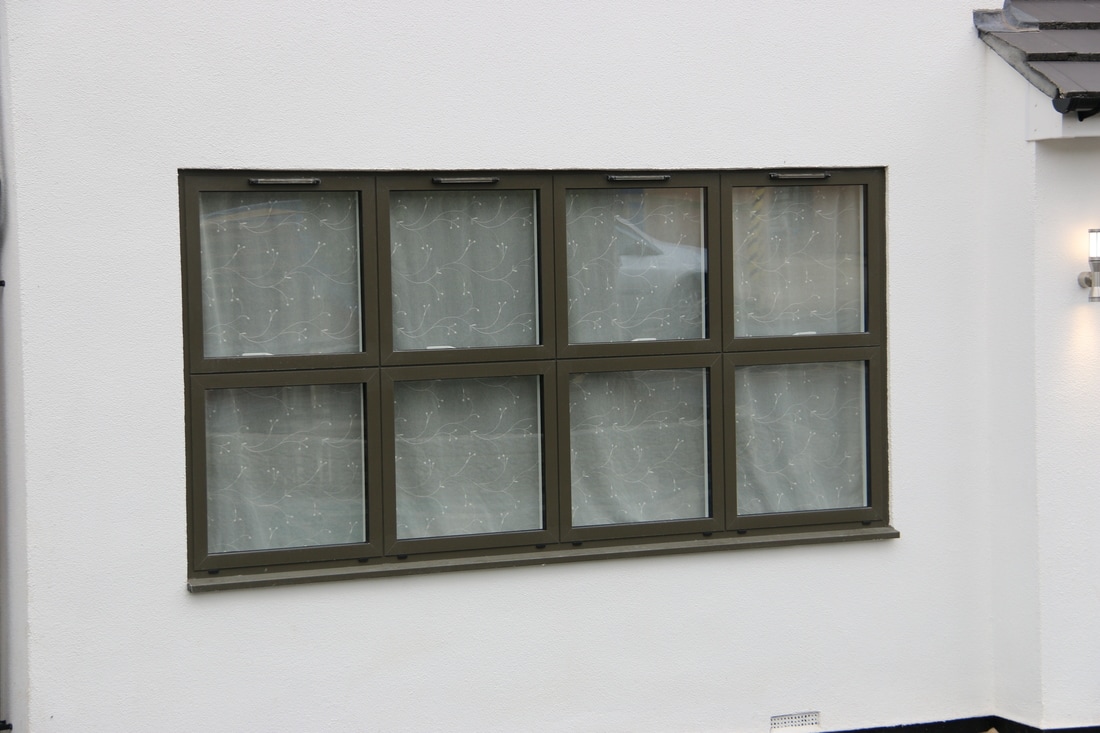 Dark-framed multi-pane window on a period home – Inspired Glazing