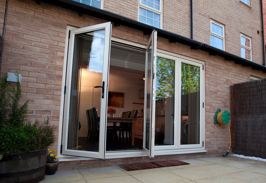 White UPVC French doors on a brick home – Inspired Glazing, UPVC windows in Kent